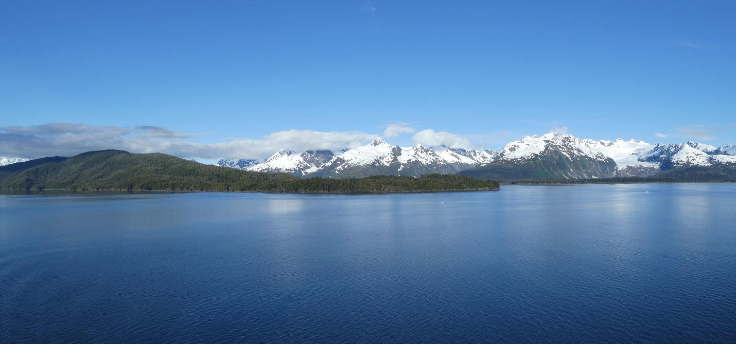A lake with mountains in the background Description automatically generated with medium confidence